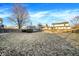 Wide backyard shot with lawn, privacy fence, shed, with neighboring houses in the background at 5937 Terrytown Pkwy, Indianapolis, IN 46254