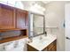 Bathroom with a white sink, framed mirror, and wooden cabinets at 5937 Terrytown Pkwy, Indianapolis, IN 46254