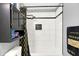 The bathroom showcases a shower with black and white tile and a black shower curtain at 5937 Terrytown Pkwy, Indianapolis, IN 46254