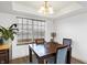 Bright dining room with a chandelier, large window, and a table that seats four people at 5937 Terrytown Pkwy, Indianapolis, IN 46254