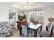 Well-lit dining area with a classic chandelier and view to an adjacent room at 5937 Terrytown Pkwy, Indianapolis, IN 46254