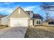 Charming home featuring a two-car garage, gray siding, and well-maintained landscaping at 5937 Terrytown Pkwy, Indianapolis, IN 46254