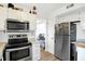 Efficient kitchen with stainless steel appliances including a microwave, oven, and refrigerator at 5937 Terrytown Pkwy, Indianapolis, IN 46254