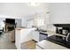 Open kitchen with stainless steel appliances, breakfast bar overlooking the adjacent living room at 5937 Terrytown Pkwy, Indianapolis, IN 46254