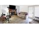 Comfortable living room with a fireplace, TV, sofa, desk, and a glass paneled door at 5937 Terrytown Pkwy, Indianapolis, IN 46254