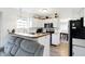 View from the kitchen of stainless appliances, breakfast bar, dining room table, and chairs at 5937 Terrytown Pkwy, Indianapolis, IN 46254