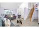Spacious living room with high ceilings, cozy seating, and an open staircase at 5937 Terrytown Pkwy, Indianapolis, IN 46254
