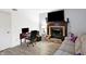 Living room featuring a fireplace, TV, comfortable seating, and modern workstation at 5937 Terrytown Pkwy, Indianapolis, IN 46254