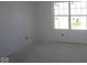 A bright bedroom with a large window offering natural light and a view of the outside at 6120 Paperbark Way, Indianapolis, IN 46259