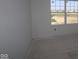 Bright, unfinished room with a window showcasing the outside view, ready for customization at 6120 Paperbark Way, Indianapolis, IN 46259
