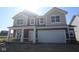 New two-story home with neutral brown siding, covered porch, and attached two car garage at 6120 Paperbark Way, Indianapolis, IN 46259