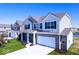 New two-story home showing detailed brickwork, white trim, well-kept lawn, and a paved driveway at 6120 Paperbark Way, Indianapolis, IN 46259