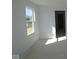 A bright, unfinished room with a window and doorway ready to be transformed into your desired space at 6120 Paperbark Way, Indianapolis, IN 46259