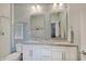 Bright bathroom featuring double sinks, granite countertops, and a glass-enclosed shower at 620 Pomeroy St, Indianapolis, IN 46202