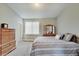 Comfortable bedroom with a soft carpet, dresser, and a bright window at 620 Pomeroy St, Indianapolis, IN 46202