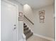 Foyer showcasing a staircase with patterned carpet and framed artwork on the wall at 620 Pomeroy St, Indianapolis, IN 46202