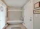 Inviting mudroom area featuring a bench, coat hooks, and neutral decor at 620 Pomeroy St, Indianapolis, IN 46202