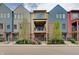 Charming multi-colored townhomes feature brick accents and small front yard landscaping at 620 Pomeroy St, Indianapolis, IN 46202