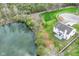 Aerial view of a charming house nestled on a lot backing onto a picturesque pond with lush greenery at 6507 Tram Ct, Indianapolis, IN 46260