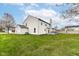 Expansive backyard with lush green grass, mature trees, and a back deck, perfect for outdoor living and entertaining at 6507 Tram Ct, Indianapolis, IN 46260