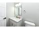 Clean bathroom with white vanity, marble countertop, a modern mirror, and a white toilet with fixtures at 6507 Tram Ct, Indianapolis, IN 46260