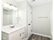 Bright bathroom featuring a white vanity with marble countertop, updated fixtures, and a tub/shower combo at 6507 Tram Ct, Indianapolis, IN 46260
