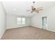 Large primary bedroom with neutral walls, carpeting, and ceiling fan offers ample space and natural light at 6507 Tram Ct, Indianapolis, IN 46260