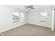 Bright room features neutral walls, carpeting, a ceiling fan, and natural light from the windows on the second floor at 6507 Tram Ct, Indianapolis, IN 46260