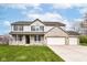 Charming two-story home with a brick facade, a three-car garage, covered porch, and a well-manicured lawn at 6507 Tram Ct, Indianapolis, IN 46260