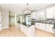 Modern kitchen with white cabinets, a black countertop island, stainless steel appliances, and wood flooring at 6507 Tram Ct, Indianapolis, IN 46260