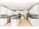Modern kitchen with white cabinets, a black countertop island, and stainless steel appliances at 6507 Tram Ct, Indianapolis, IN 46260