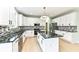 Bright kitchen featuring white cabinets, black countertops, stainless steel appliances, and a center island at 6507 Tram Ct, Indianapolis, IN 46260