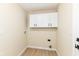 Functional laundry room with upper cabinets and neutral walls at 6507 Tram Ct, Indianapolis, IN 46260