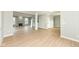 Spacious open-concept living area with wood floors, a stone fireplace, and neutral wall paint throughout at 6507 Tram Ct, Indianapolis, IN 46260