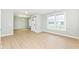 Spacious living room with wood floors, decorative wall panels, a large window, and a modern front door at 6507 Tram Ct, Indianapolis, IN 46260