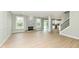 Open concept living room with fireplace, sliding door access to the deck, and staircase access to the second floor at 6507 Tram Ct, Indianapolis, IN 46260