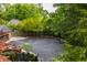 Aerial view of driveway, landscaping, and basketball court, offering a private backyard space at 654 E 79Th St, Indianapolis, IN 46240