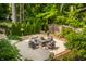 An aerial view of the backyard patio with outdoor furniture that overlooks lush landscaping at 654 E 79Th St, Indianapolis, IN 46240