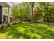 Expansive backyard featuring lush green grass, mature trees, and a classic black fence at 654 E 79Th St, Indianapolis, IN 46240