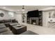 Finished basement featuring modern gray walls, plush carpeting, and a cozy fireplace at 654 E 79Th St, Indianapolis, IN 46240