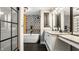 Beautiful bathroom with double vanity, soaking tub, and striking black and white tile at 654 E 79Th St, Indianapolis, IN 46240