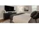 Stylish bedroom showcasing a dark dresser, a large screen TV and wood flooring at 654 E 79Th St, Indianapolis, IN 46240