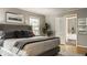 Comfortable bedroom featuring a king-size bed, wood floors, and ensuite bathroom at 654 E 79Th St, Indianapolis, IN 46240