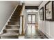 Inviting entryway featuring decorative tile, staircase, and dining area with natural light at 654 E 79Th St, Indianapolis, IN 46240