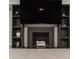 A close up of a modern fireplace with built in bookshelves and decorative accents at 654 E 79Th St, Indianapolis, IN 46240