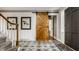 Stylish foyer with a sliding barn door, unique tile flooring, and staircase at 654 E 79Th St, Indianapolis, IN 46240