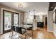 Open concept kitchen and dining area with stainless steel appliances and modern decor at 654 E 79Th St, Indianapolis, IN 46240