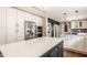 Island kitchen boasts white cabinets, stainless appliances, and a quartz countertop island at 654 E 79Th St, Indianapolis, IN 46240