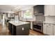 Open-concept kitchen with a large island, stainless steel appliances, and stylish backsplash at 654 E 79Th St, Indianapolis, IN 46240