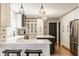 Modern kitchen with white cabinets, stainless steel appliances, and sleek countertops at 654 E 79Th St, Indianapolis, IN 46240